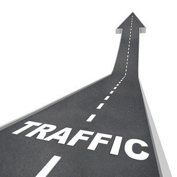 The word Traffic on a road rising up to represent increased activity on the web or transportation system such as freeways and highways