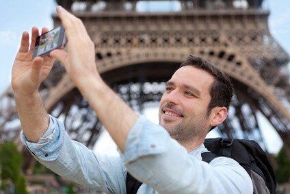 View of Young attractive tourist taking selfie in Paris