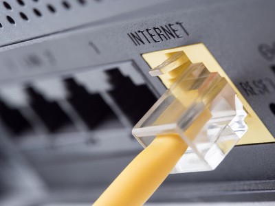 Network yellow cable connected to a router or modem