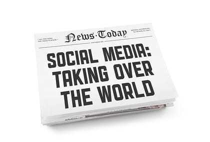 A stack of newspapers with headline "Social media: Taking over the world". Isolated on white.