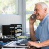 How to sell more online – use the phone…! Man at computer using phone